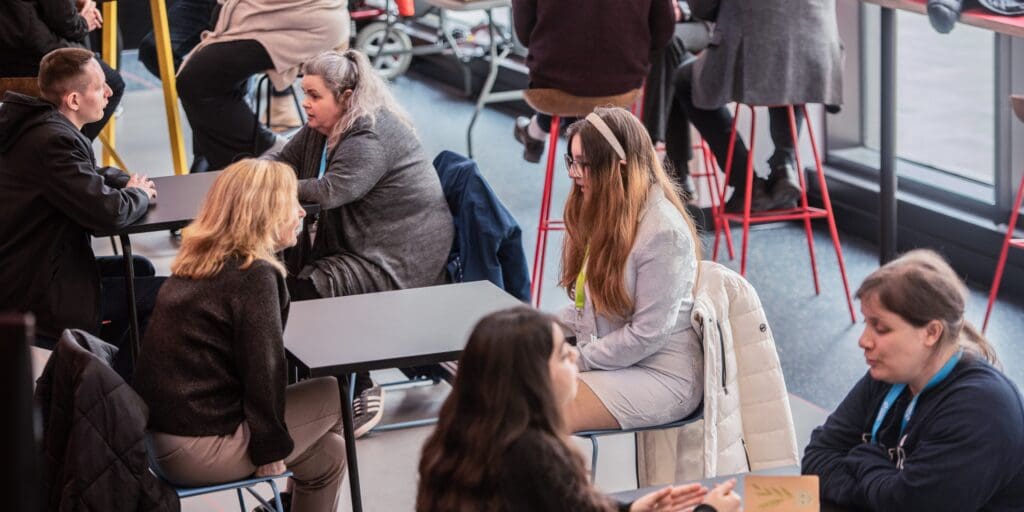 Two people sat at a table having a conversation