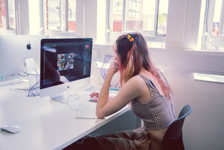 Girl using Adobe photoshop on computer