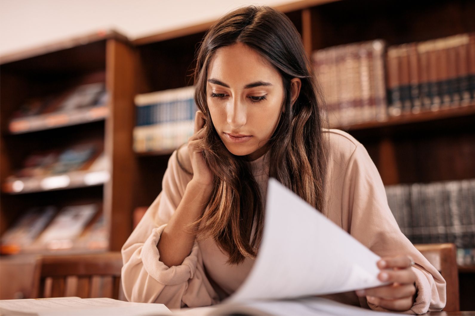 Potential female student reading through college application