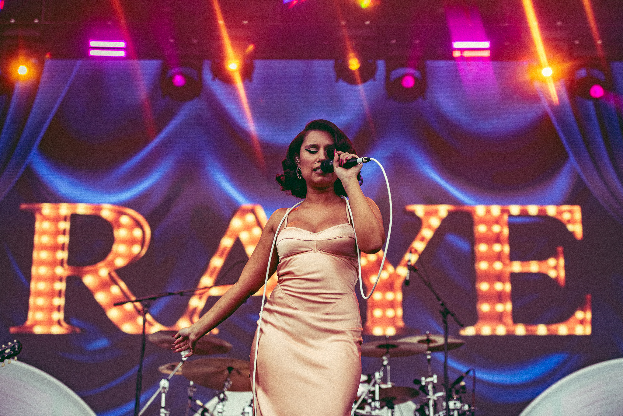 Raye performing on festival stage