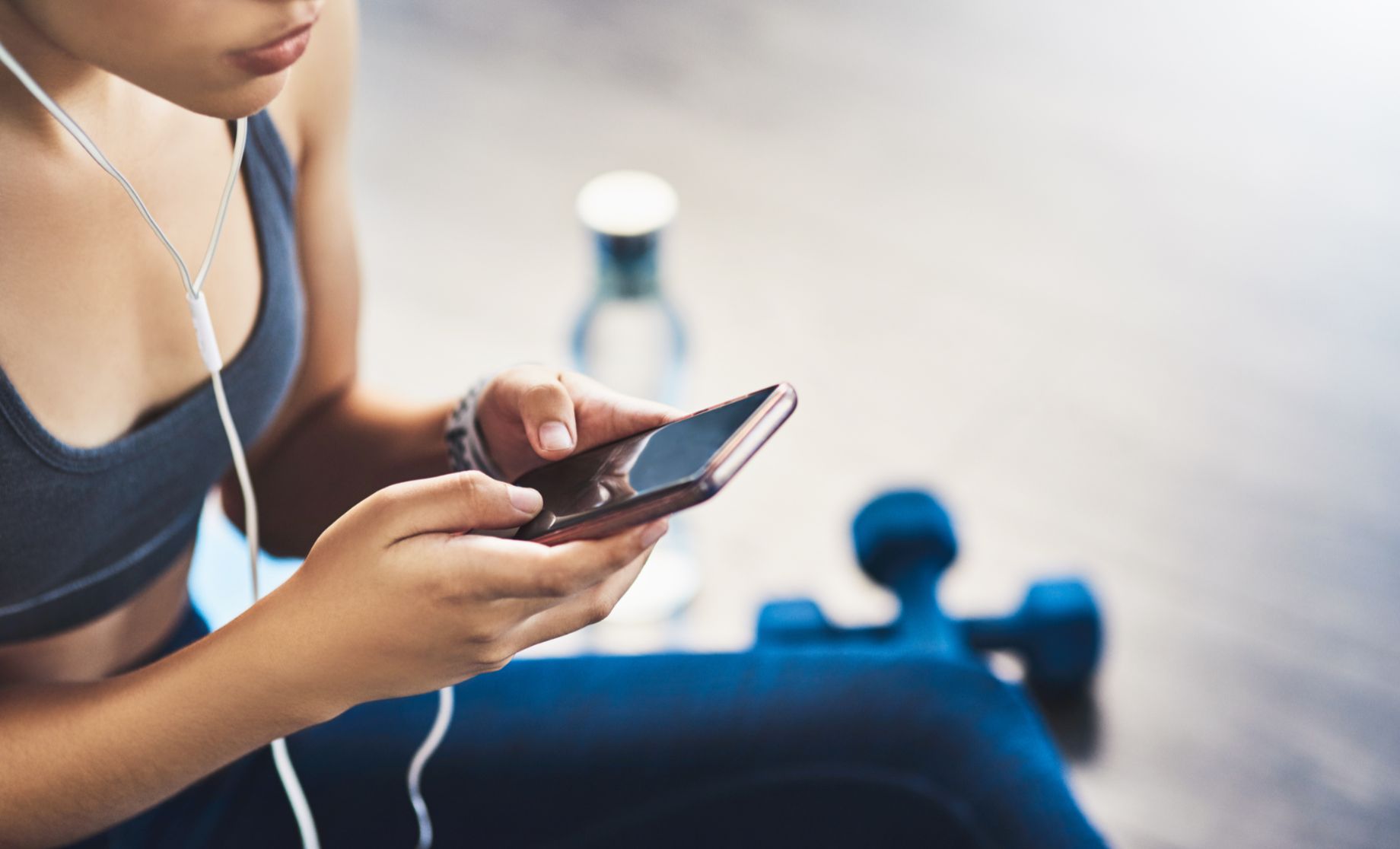 Gym goer listening to music playlist