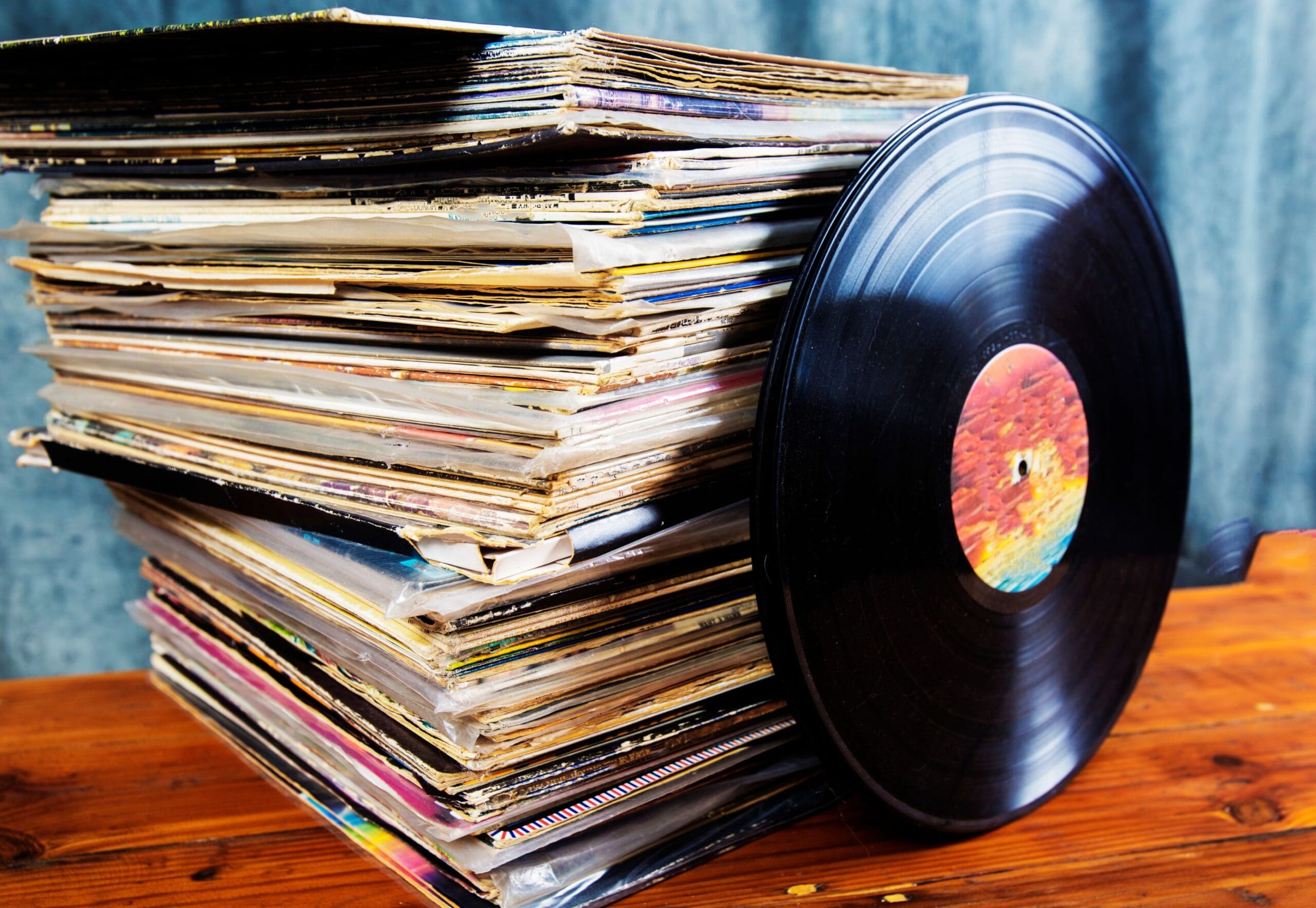 Pile of records with vinyl leaning on it