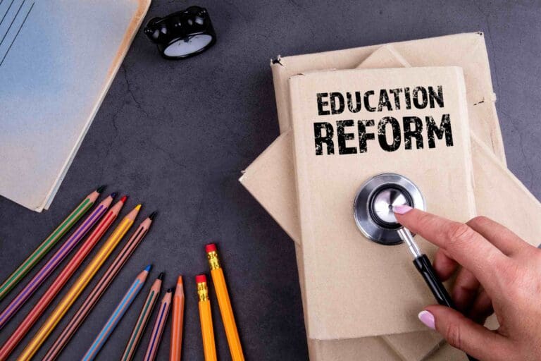 Education Reform concept, with a lock and key built into cardboard that says 'EDUCATION REFORM' on it