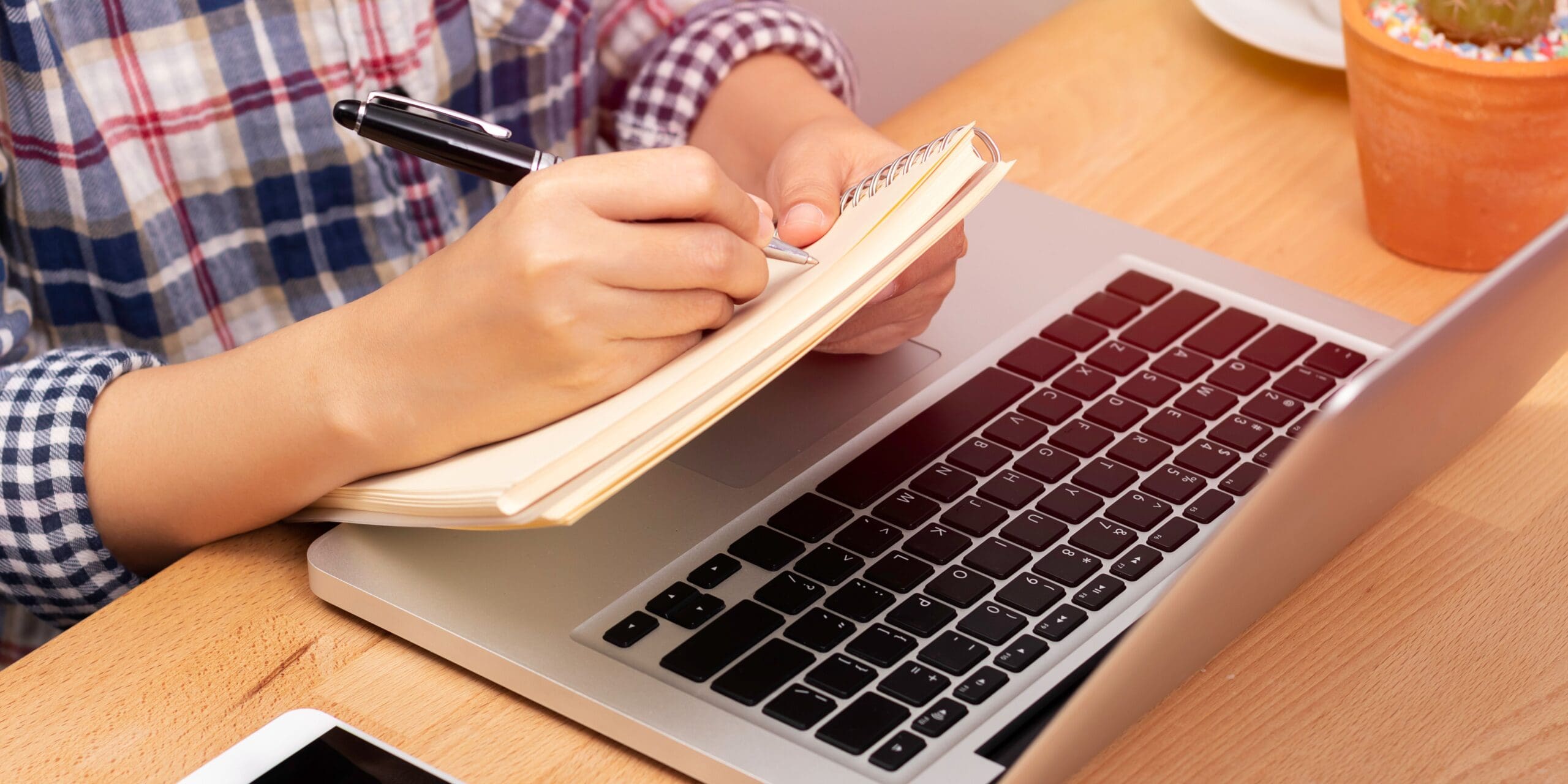 A person writing in a notebook