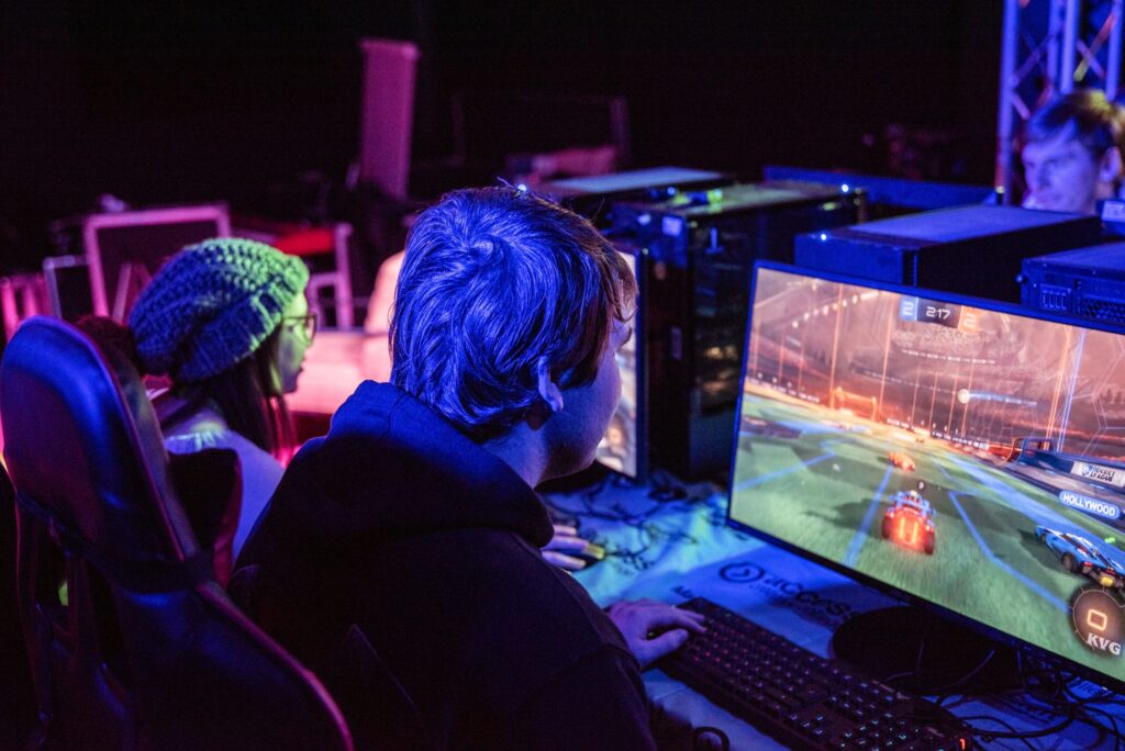 Esports college course students side-by-side, playing Rocket League