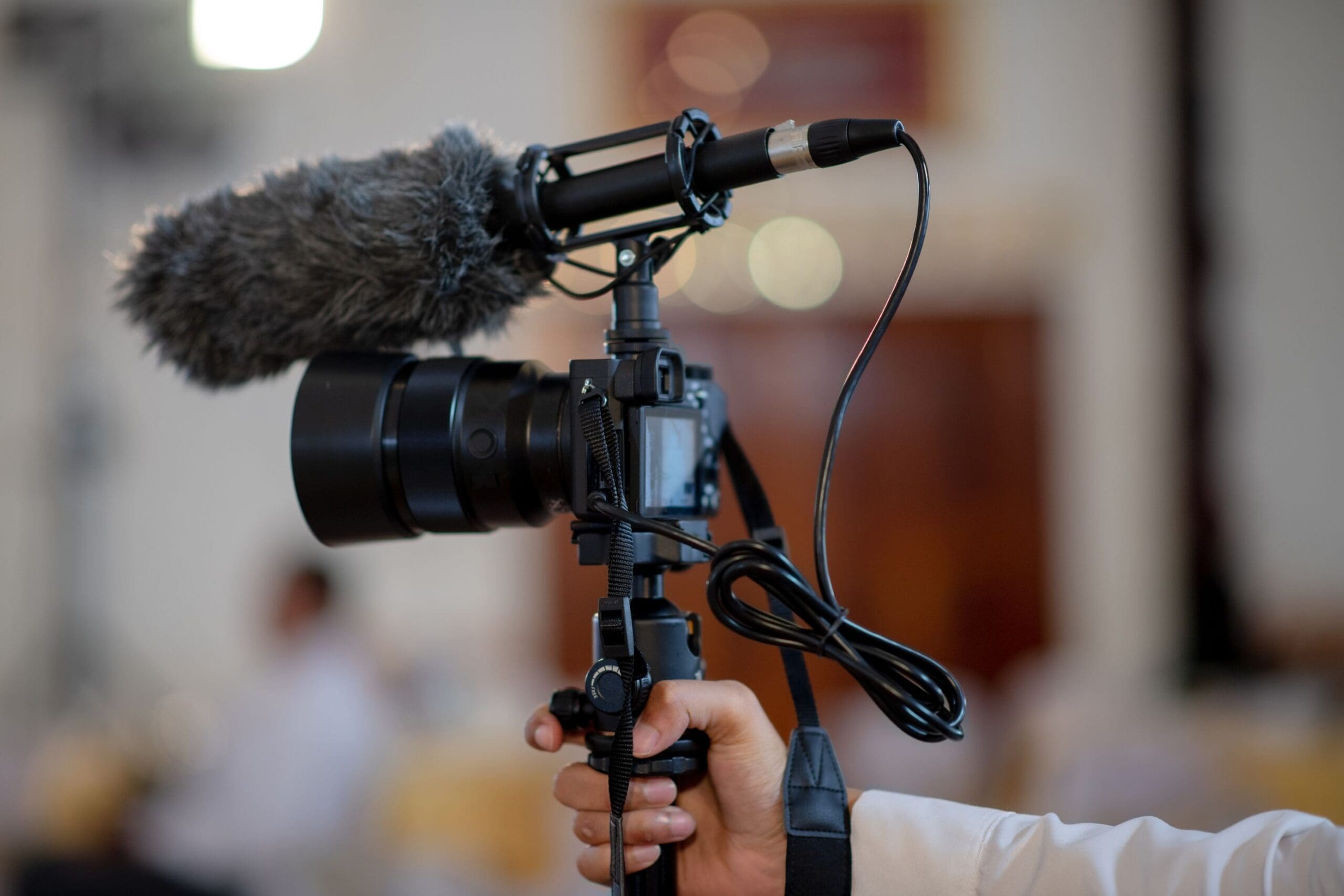 Professional videographer holding camera