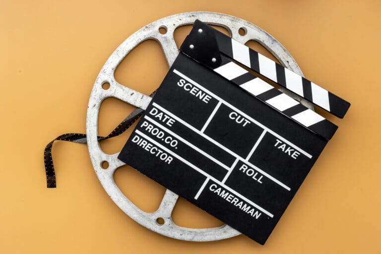 Clapperboard and empty film reel