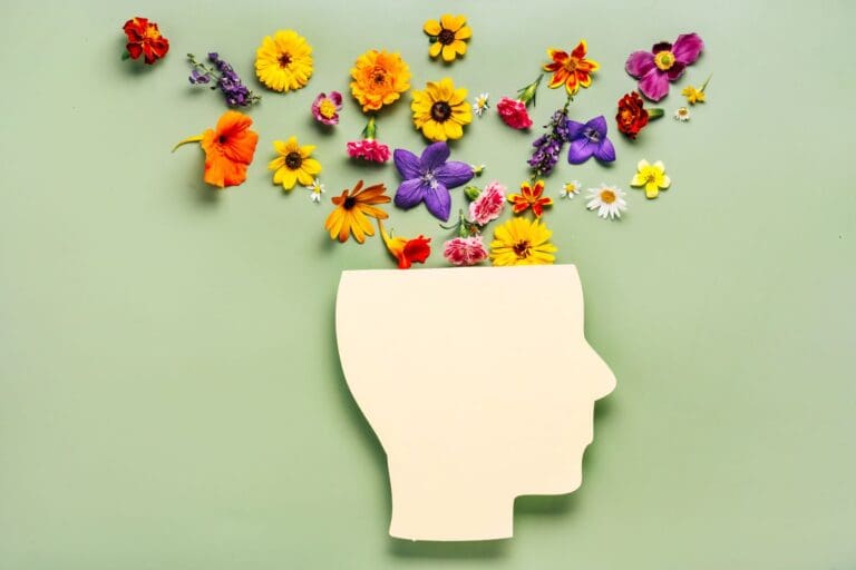 Mental health concept of flowers pouring out of person's brain